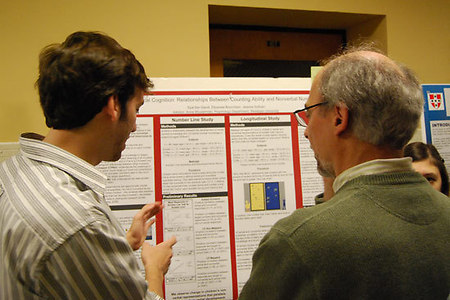 Eyal Bar-David '09 explains his research to John Seamon, Prof. of Psychology