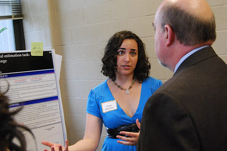 Annie Paladino '09 explains her research to Joe Bruno, Vice President of Academic Affairs and Provost. Paladino's study was titled, "Children's Performance on Numerical Estimation Task: Identifying the Source of Change."