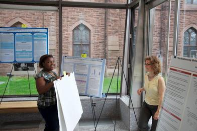 Behind the scenes of the poster session. Student worker Sandy Doursier and administrative assistant Cathy Race