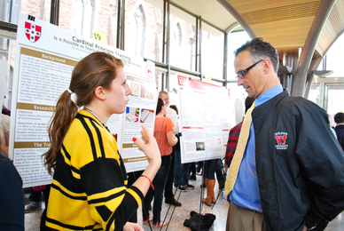 Carolyn Mortell discusses her poster with President Michael Roth