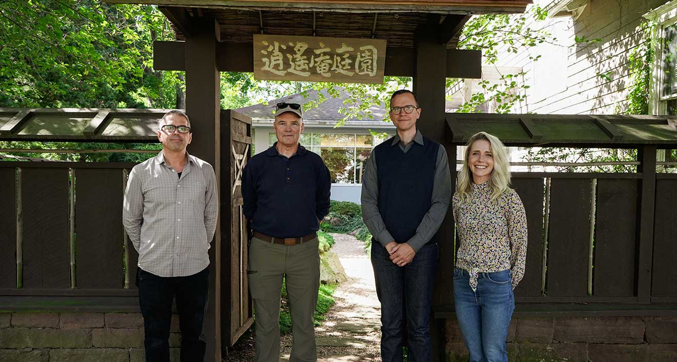 Paul Theriault, Center for the Arts art preparator; Stephen Morrell, Japanese garden architect; Ben Chaffee, associate director of visual arts; and Rosemary Lennox, exhibitions manager, gather outside the Mansfield Freeman Center for East Asian Studies Japanese Garden during its 25th-year celebration.