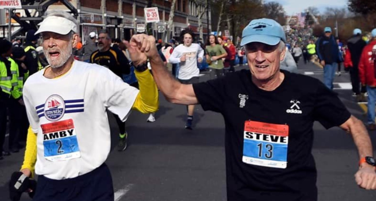 Amby Burfoot ’68 (left) finishes his 59th consecutive Manchester Road Race, setting a new record. He finished the race with friend Steve Gates (right).
