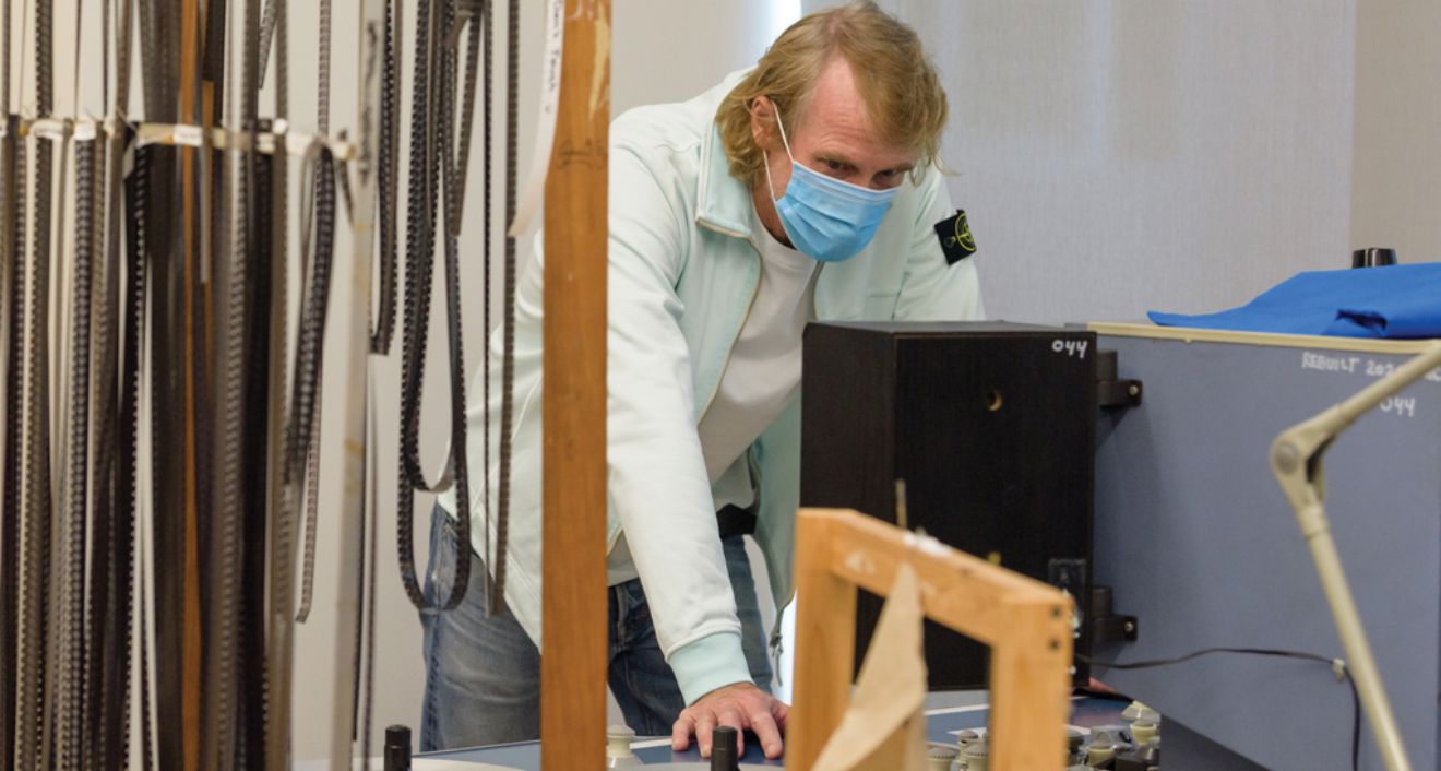 Director/producer Michael Bay ’86, a former Wesleyan art major, inspects the editing equipment (located in the production wing he funded) at the launch of the new Jeanine Basinger Center for Film Studies. Photo by Nick Caito Photo