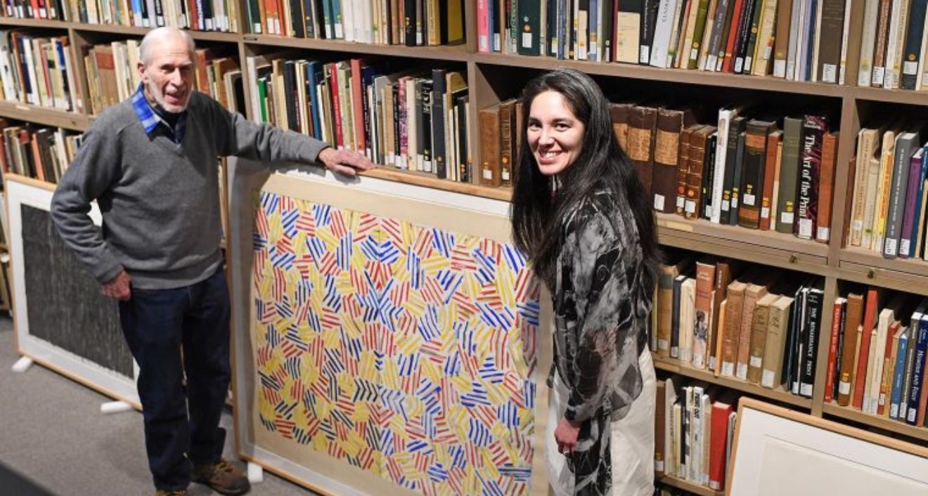 Former Davison Art Center curator Richard “Dick” Field P’09 and current DAC curator Miya Tokumitsu discuss one of Jasper Johns’ silkscreens titled “Corpse and Mirror,” 1976, at the DAC. In March, all collections will be moved to storage in Olin Library. (Photo by Olivia Drake)