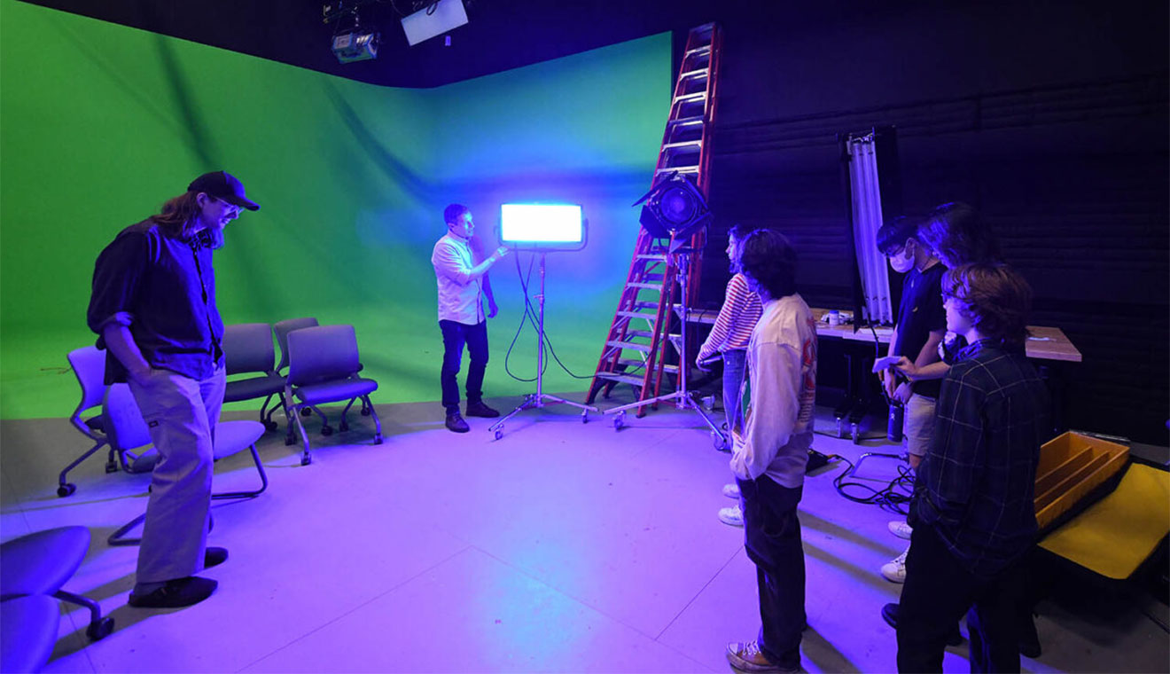 Richard Parkin will be promoted to associate professor of the practice in film studies on July 1. Parkin, pictured above teaching students about various lighting techniques, will teach Advanced Filmmaking and Sight and Sound next fall. (Photo by Olivia Drake)