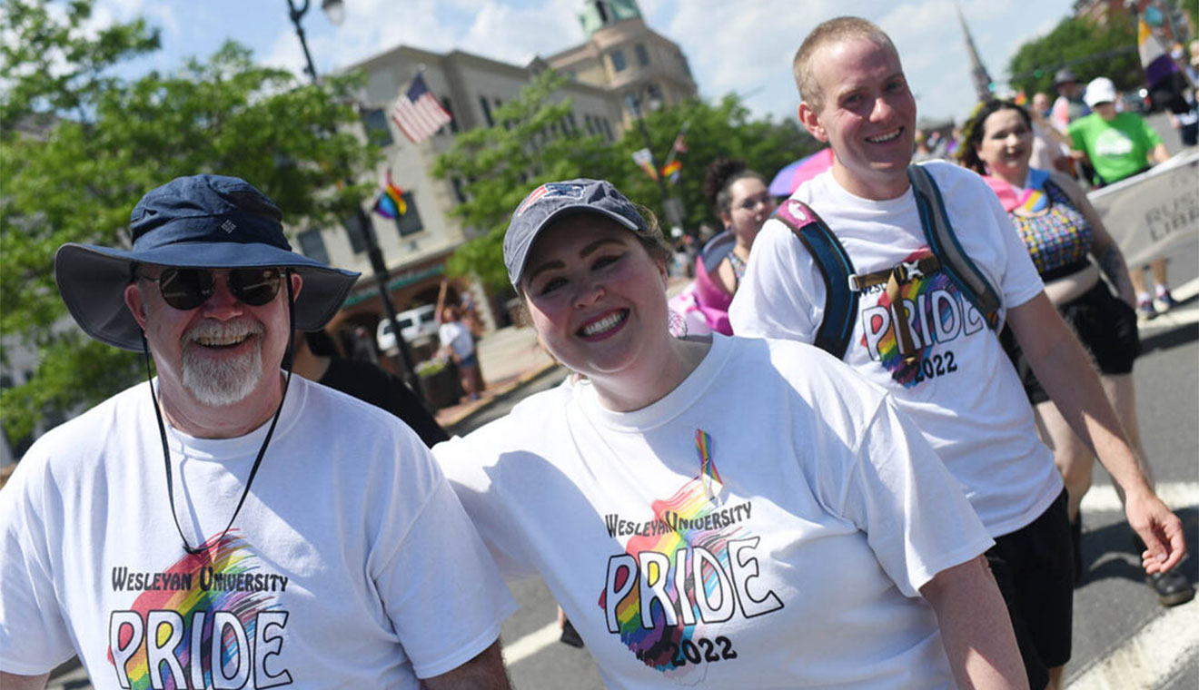Andrew White, Caleb T. Winchester University Librarian; Kelly Dunn, dean for the Class of 2025; and graduate student Zack Drum were all smiles walking in the PrideFEST parade.