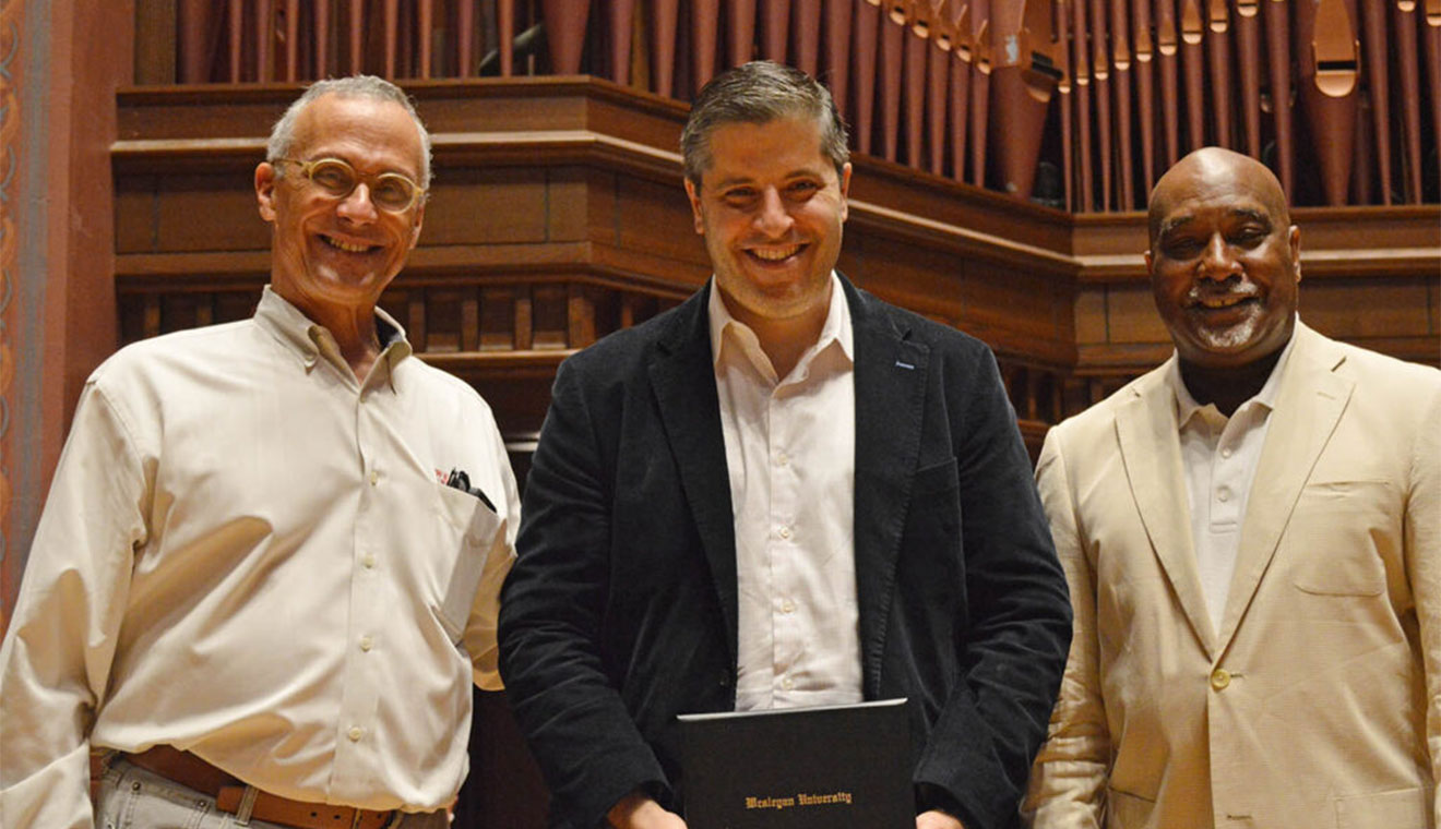 Wesleyan President Michael Roth ’78 and Alumni Association Chair David Hill ’86 present Bill Sherman ’02 with the James L. McConaughy Jr. Memorial Award.