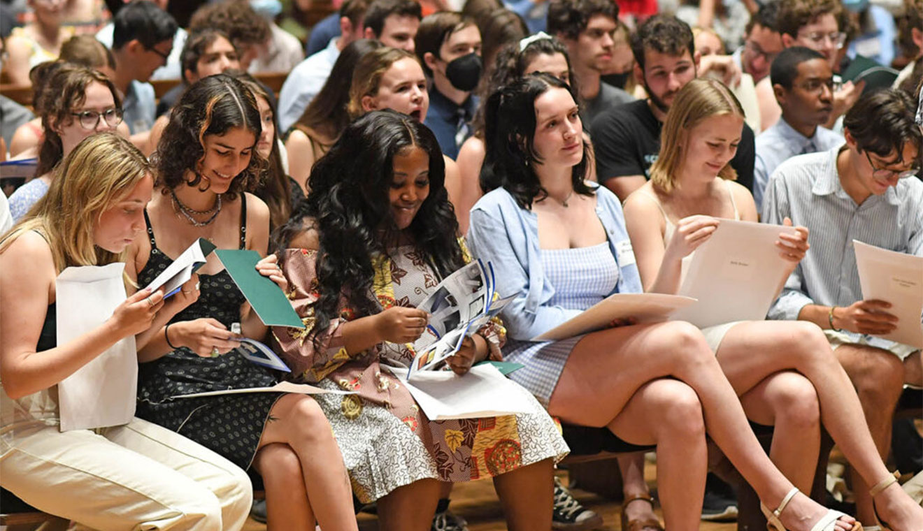 The newest members of Wesleyan’s Phi Beta Kappa Chapter examine their welcome packets during the initiation ceremony on May 21 in Memorial Chapel.