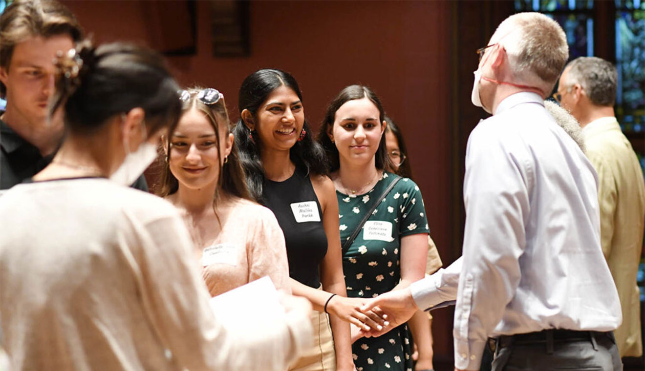 Aashni Parikh ’22 shakes hands with PBK President Daniel Smyth during the initiation ceremony.