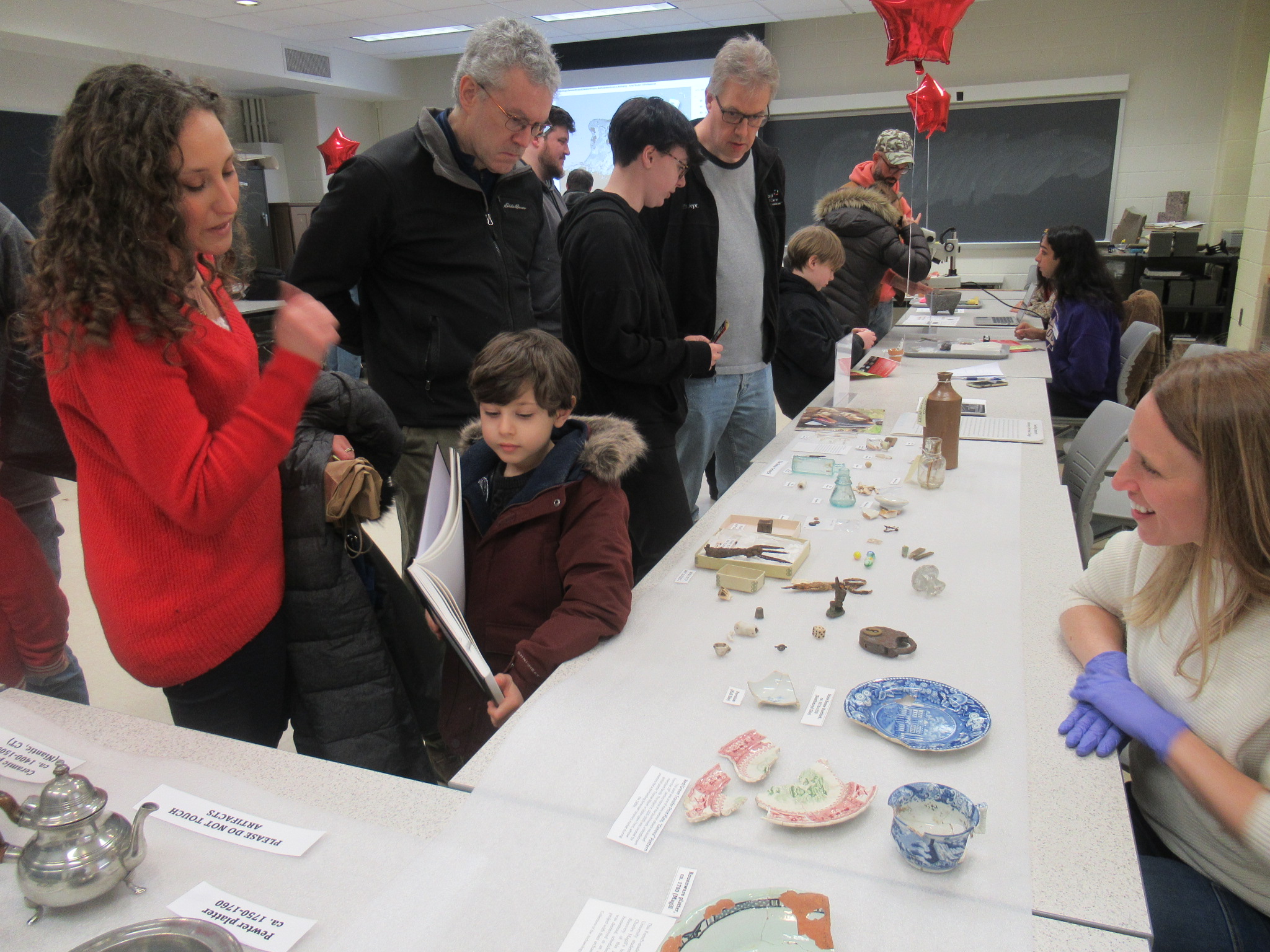 Archaeology Collections Manager Wendi Field Murray (seated right) greets visitors to the Archeology Collections open house on March 4. Photo by Maia Bronfman ’24.