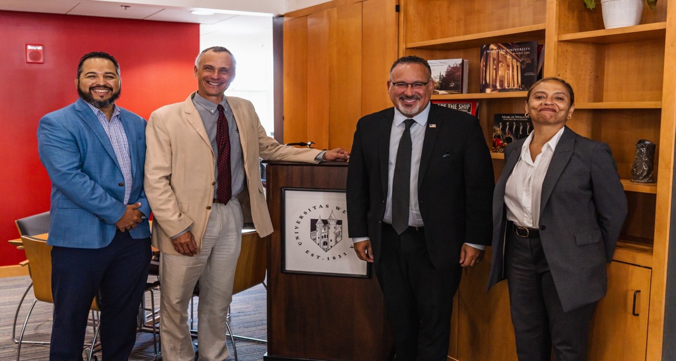 Vice President and Dean of Admission and Financial Aid Abdul-Malik Gonzalez ’96, President Michael S. Roth ’78, U.S. Secretary of Education Miguel Cardona, and Provost and Senior Vice President for Academic Affairs Nicole Stanton