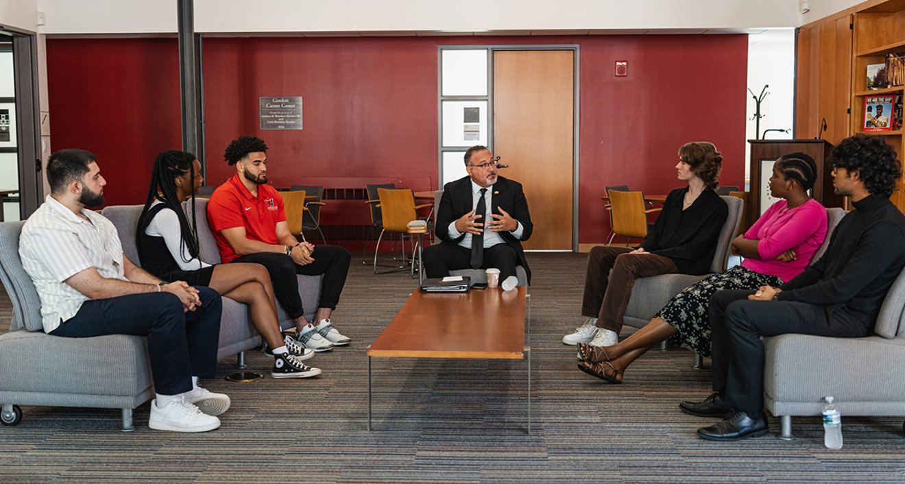U.S. Secretary of Education Miguel Cardona meets with Ahmed Almohamed ’24, Darren Boyce ’25, Omar Gonzalez ’26, Christa Ishimwe ’23, Ezra Jenifer ’23, and Sukenia Wilson ’23. (Meka Wilson)