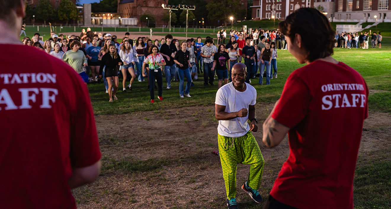 Associate Professor of Dance Iddi Saaka (center) leading students in a warm up dance to Ghanaian music. (Photo by Meka Wilson)