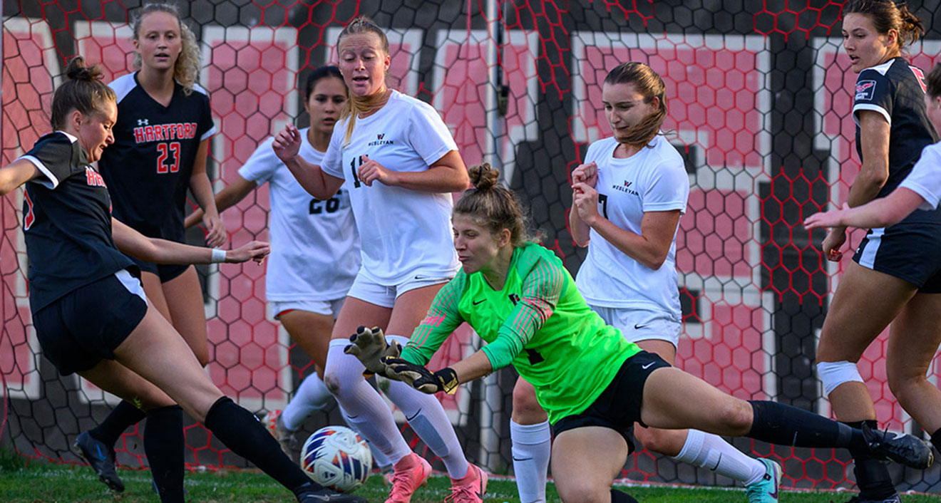 Goalkeeper Molly Brumbach ’25 stops a shot against Hartford on Oct. 1. Brumbach was named NESCAC Defensive Player of the Year this season. (Photo by Steve McLaughlin)