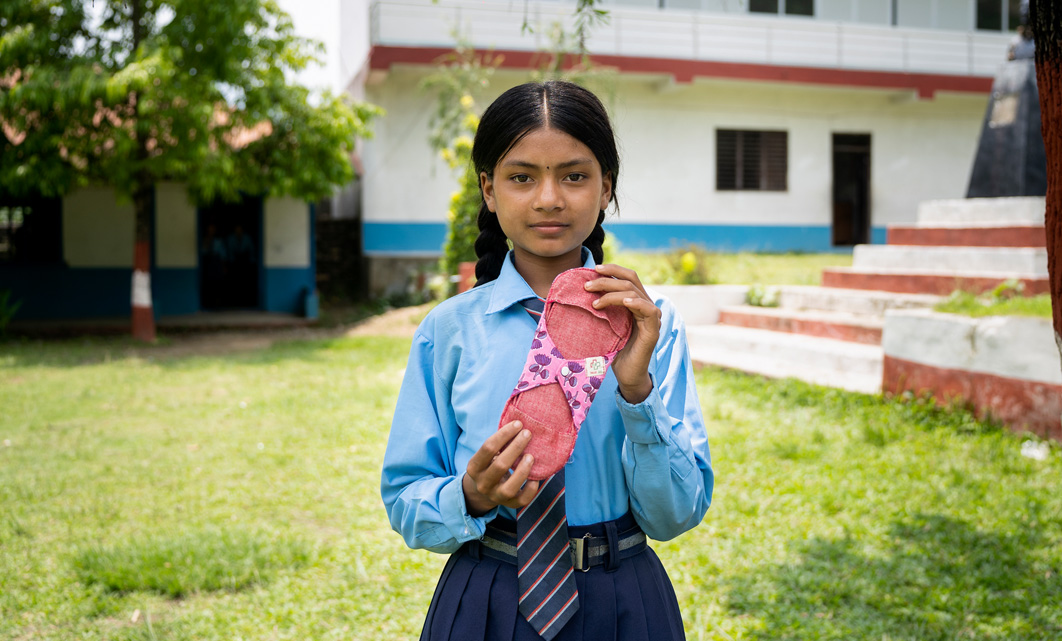 girl holding a reusable menstrual pad