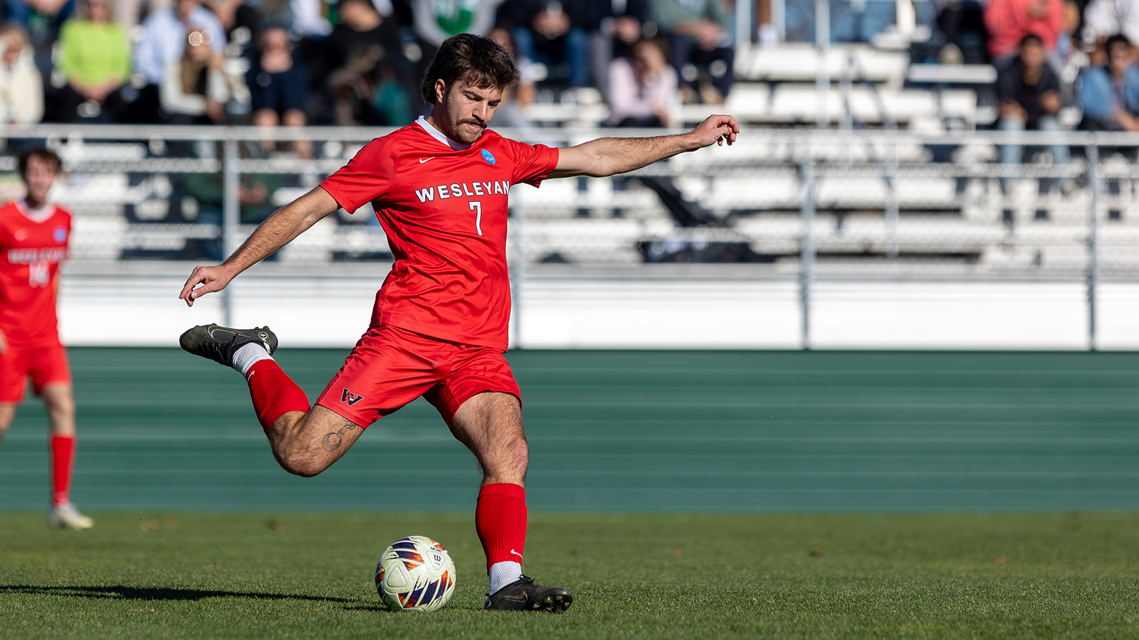 Player kicking soccer ball