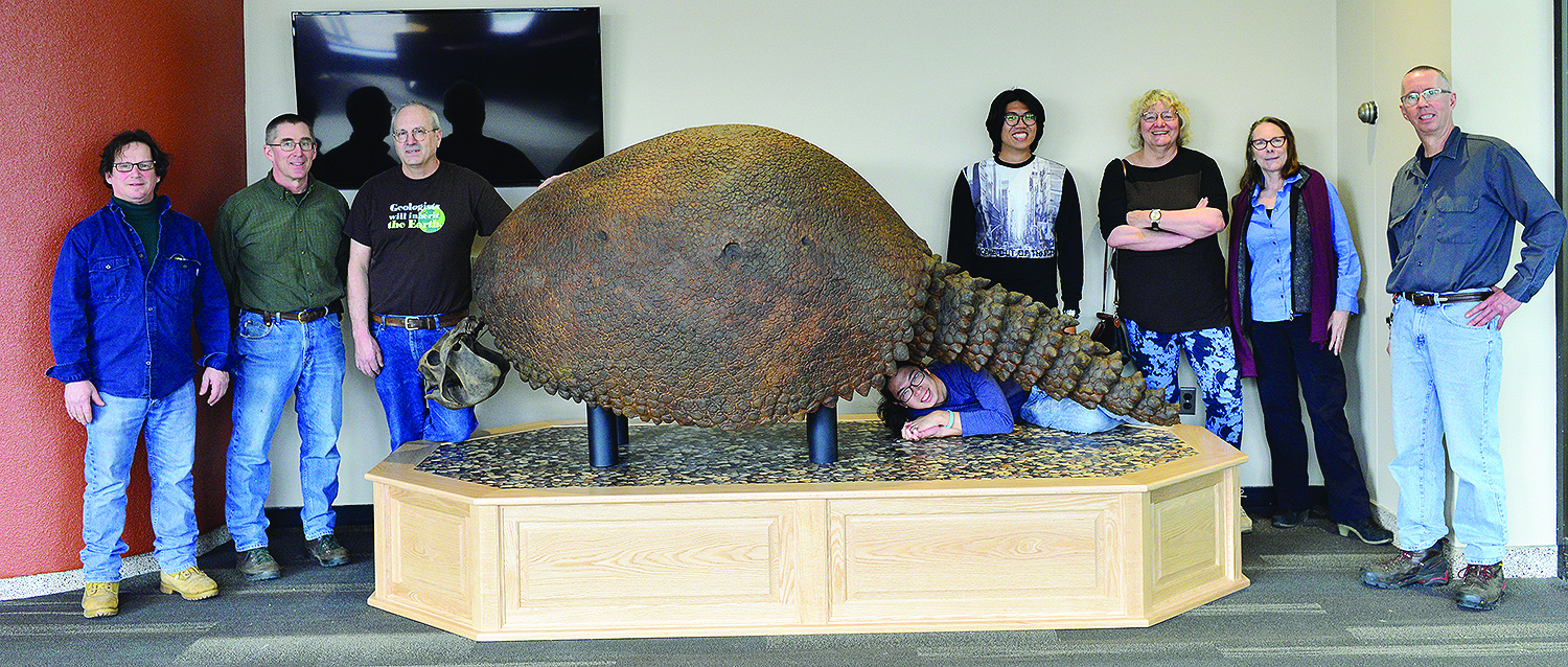 Faculty, students, and staff members posing with a glyptodon 