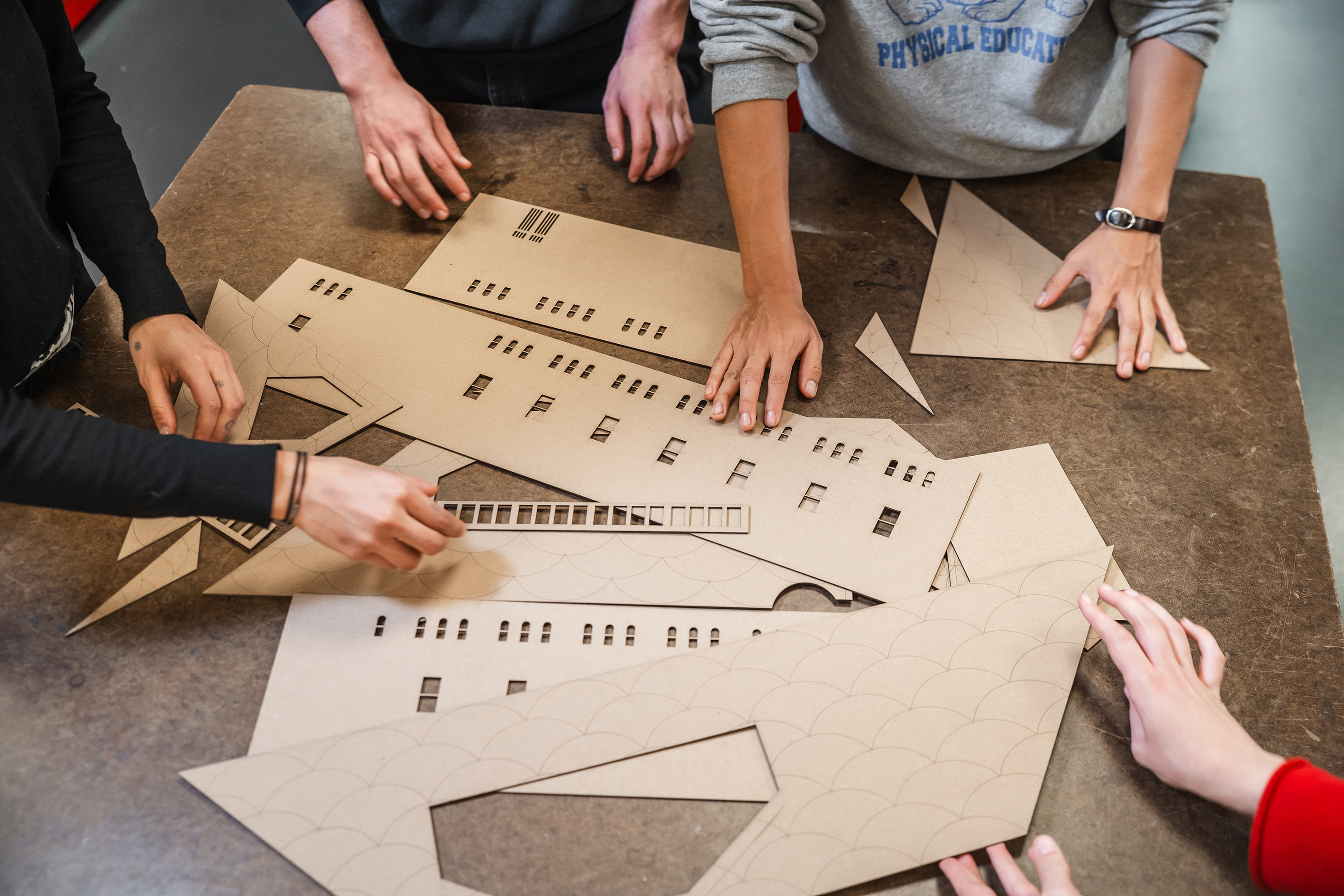 hands sorting through cutouts