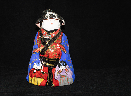 Painted doll on black background 