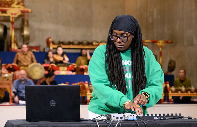 Composer with electronic instrument in front of Javanese Gamelan Ensemble
