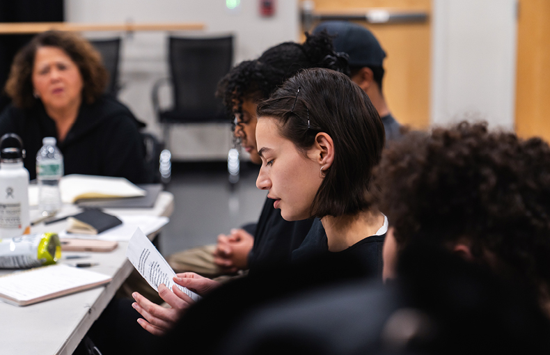 Students at table with visiting artist
