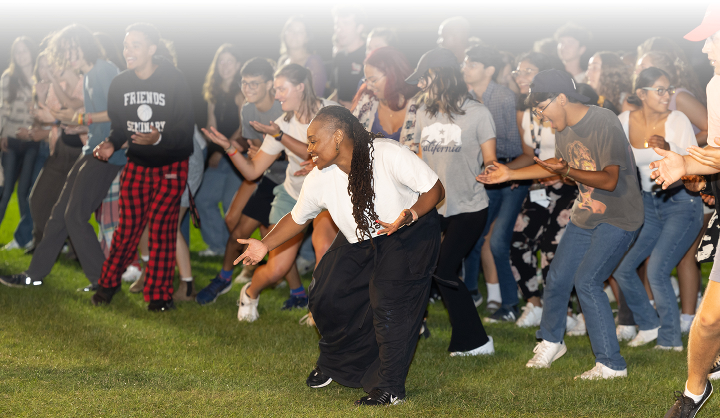 Dancer instructing audience on a field