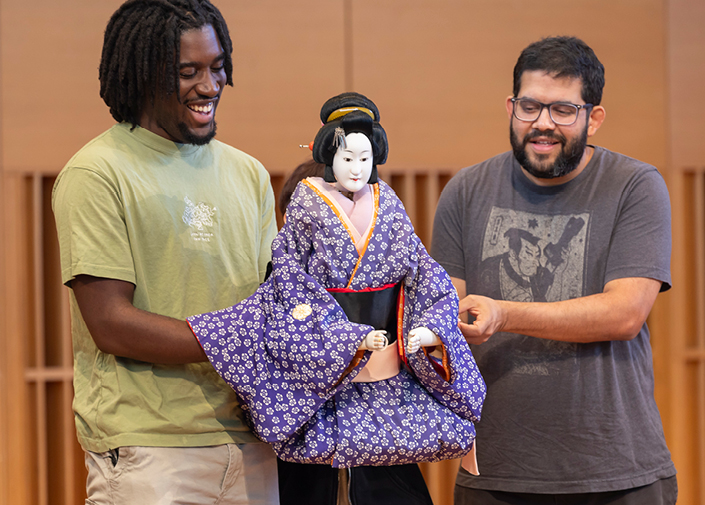Students on stage with Japanese puppet 
