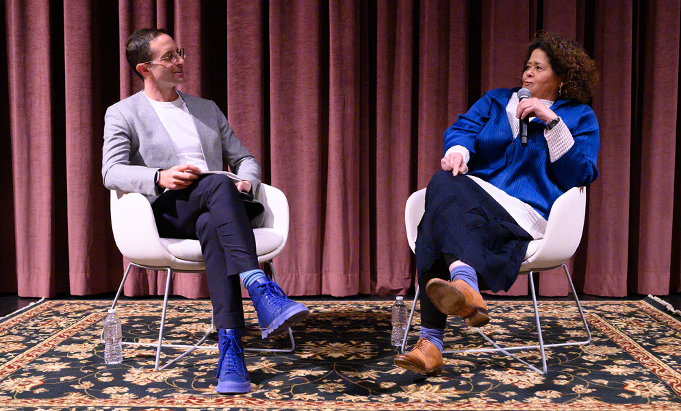 wo people in conversation on stage