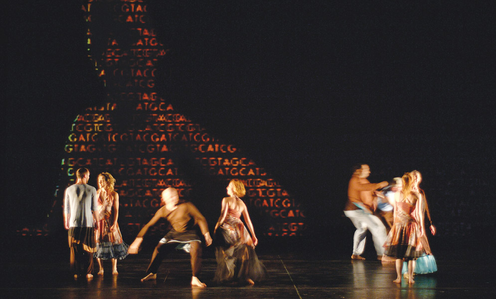 Dancers on stage with projection behind