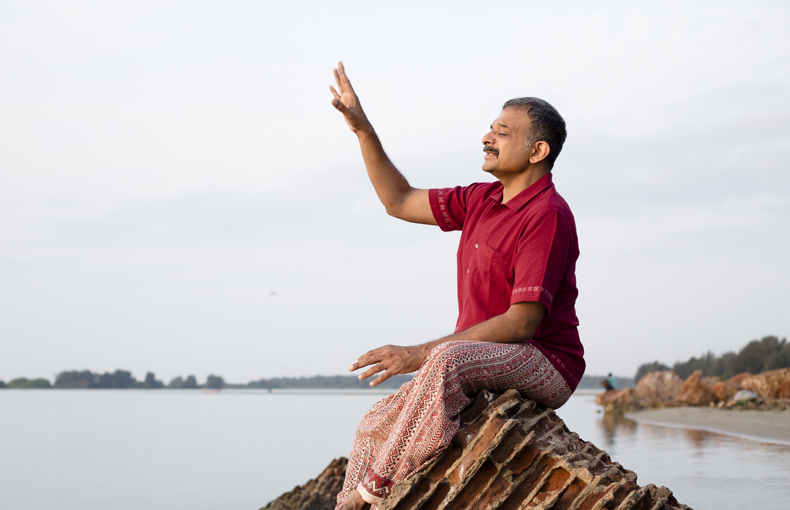 T.M. Krishna sitting on a rock. 