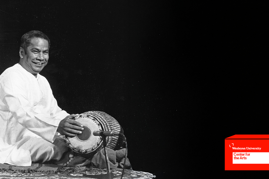 Musician playing mrdangam (double-headed drum)