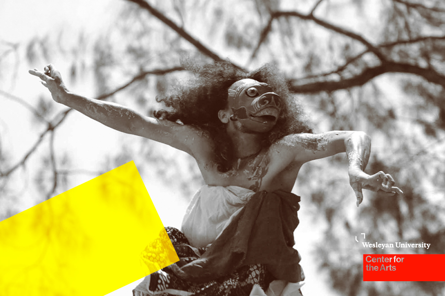 Dancer with mask in front of tree