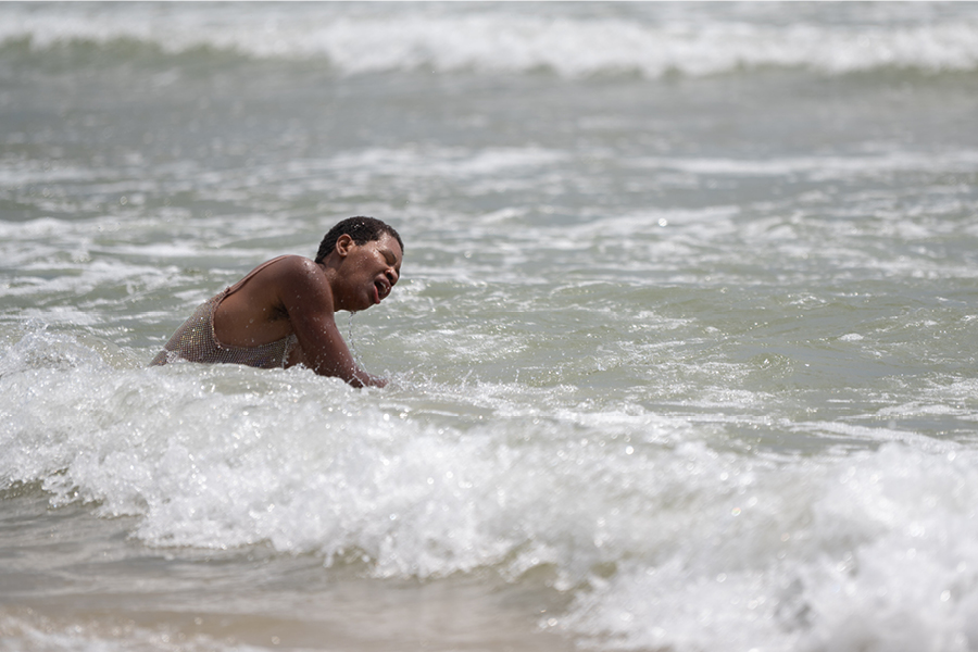 Person swimming in ocean surf
