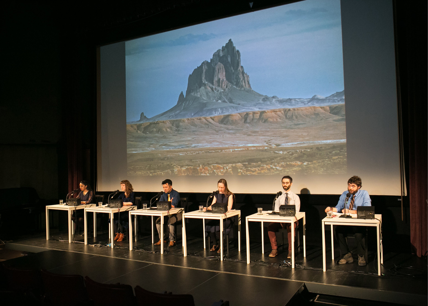 Interior of performing arts hall looking at stage and screen from seats