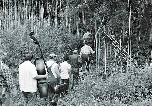 Crew and band members assembling for a shot.