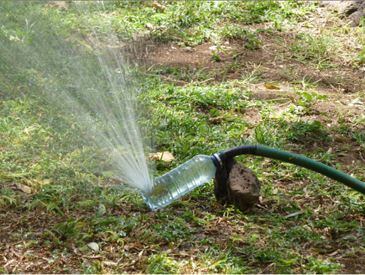 Water bottle sprinkler (To make: http://ecoprojecteer.net/2012/06/soda-bottle-sprinkler/)