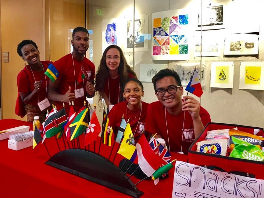 International Orientation Leaders at arrival table with international flags