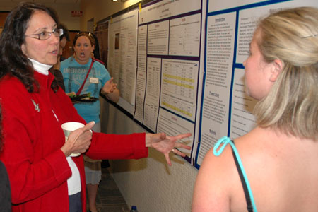 Prof. Cynthia Matthew talking with Sarah Jeffrey about her poster, "Accounting for the Association between Social Anxiety Disorder and Alcohol Abuse Disorder."