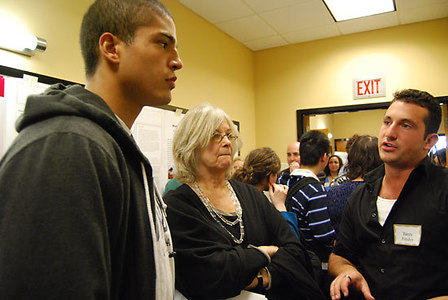 Graduate student Barry Finder '09 explains his research to John Harding '09 and Susan Carey, Professor of Psychology at Harvard University