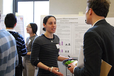 Graduate student Julia Kastenbaum talks with Matthew Kurtz, Assistant Prof. of Psychology, about her study, "Age of Acquisition Effects in Schizophrenia."