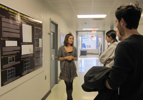 One of Professor Naegele’s students discusses research in the lab with lab tour attendees.