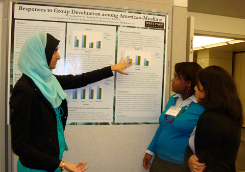 Adela Ramirez and Sandy Durosier listen intently as Tasmiah Khan presents her research at the City University of New York at the Inspiring Women in Science Conference.