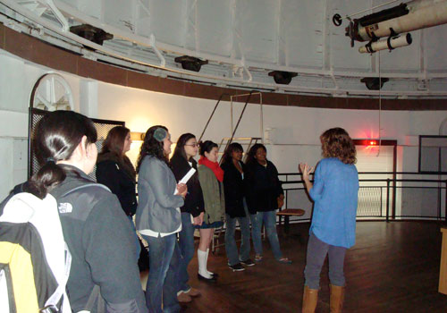 Graduate student, and WesWIS member, Katy Wyman gives a lab tour in the Department of Astronomy to high school girls participating in WesWIS’s Community Outreach Program.