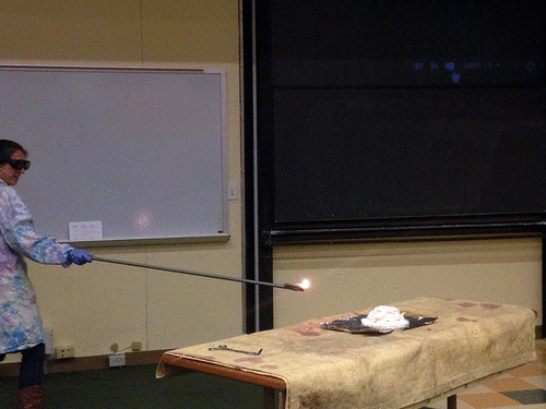 Sarah Briggs '16 ignites a large pile of "gun cotton," or nitrated cellulose